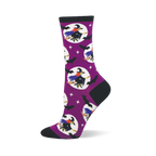 Purple crew sock with black cuff, heel, toe. Features flying witches on brooms in white moons, black bats, and white stars.