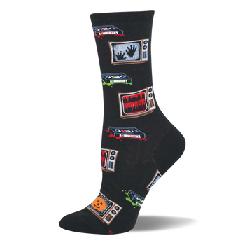 Black crew socks with retro TVs showing 'HORROR', spooky hands, and jack-o'-lanterns, plus VHS tapes with red and green splatters.