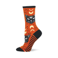Orange crew sock with black mystic cats, white eyes, crescent moons, and stars. Features black toe, heel, cuff, and striped side panel.