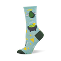 Light blue crew sock with an angelic green avocado, guacamole in a molcajete, yellow stars, and tortilla chips. Dark green heel and toe.