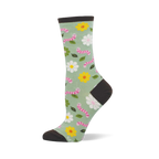 Light green crew socks with pink smiling worms, white and yellow flowers, and green leaves. Dark brown heel, toe, and cuff.