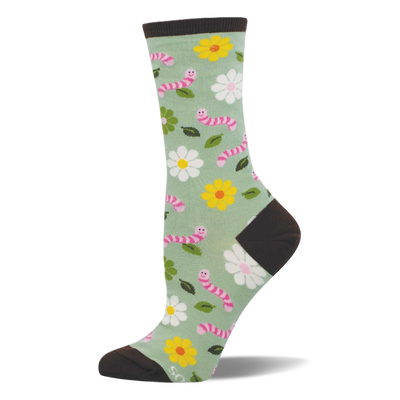 Light green crew socks with pink smiling worms, white and yellow flowers, and green leaves. Dark brown heel, toe, and cuff.