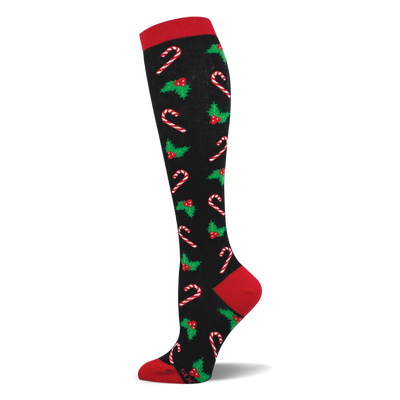 Black knee-high sock with red cuff, heel, and toe. Repeating pattern of white/red candy canes, green holly, red berries.