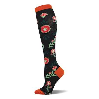 A knee-high black sock with a pattern of red flowers, light green centers, and dark green leaves. Features orange cuff, heel, and toe.