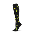 Black knee-high sock with a repeating pattern of green cocktail olives with red pimentos on skewers and white starbursts.
