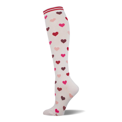 Cream knee-high sock with a scattered pattern of pink, red, and maroon hearts. Features a white and red striped cuff.