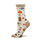 Cream crew sock with tan cuff, heel, and toe. Features a pattern of orange pumpkins, fall leaves, pumpkin spice coffee cups, and small hearts.