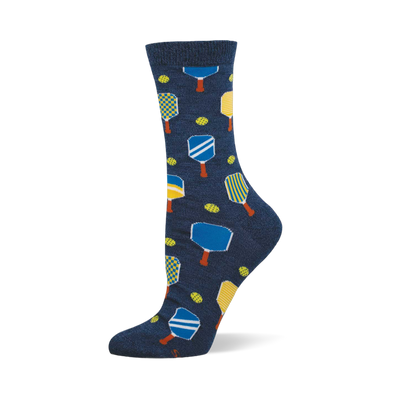 Navy blue crew socks with a repeating pattern of yellow, blue, and white pickleball paddles and yellow-green pickleballs.