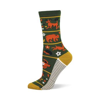 Dark green crew sock with orange deer, bear, rabbit, owl, and forest flora. Yellow toe/heel and white/black striped sole.