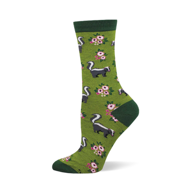 A single crew sock with an olive green base, dark green cuff, heel, and toe, featuring a pattern of black and white skunks and pink floral clusters.