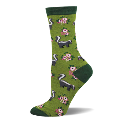 A single crew sock with an olive green base, dark green cuff, heel, and toe, featuring a pattern of black and white skunks and pink floral clusters.