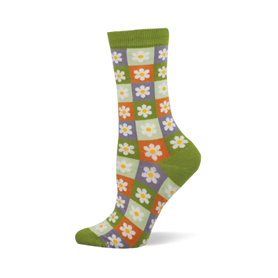 Side view of a crew sock with a checkerboard of light green, orange, and purple squares, each with a white daisy. Dark green cuff, heel, and toe.
