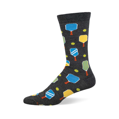Dark grey crew socks featuring a pickleball pattern with blue and yellow paddles, orange handles, and yellow pickleballs.