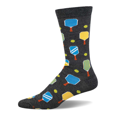 Dark grey crew socks featuring a pickleball pattern with blue and yellow paddles, orange handles, and yellow pickleballs.