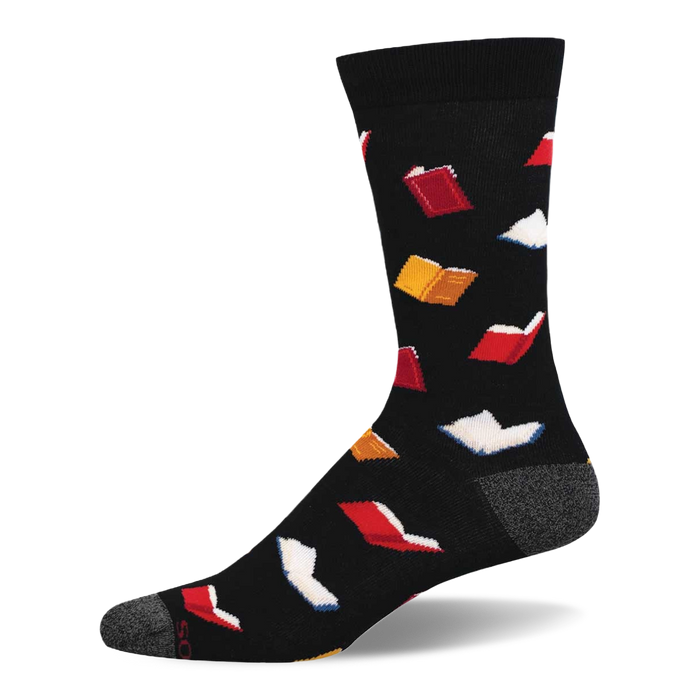 A black crew sock with a scattered pattern of small open books in red, white, and yellow. Grey heel and toe details. }}