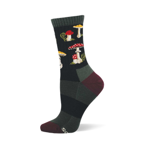 Single dark crew sock with a repeating pattern of red and white spotted mushrooms, yellow-capped mushrooms, and green foliage. Dark green cuff, burgundy heel and toe.