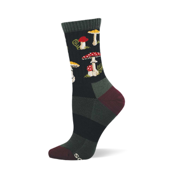 Single dark crew sock with a repeating pattern of red and white spotted mushrooms, yellow-capped mushrooms, and green foliage. Dark green cuff, burgundy heel and toe.