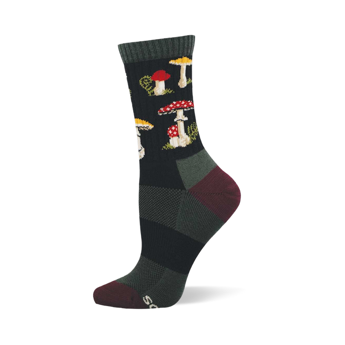 Single dark crew sock with a repeating pattern of red and white spotted mushrooms, yellow-capped mushrooms, and green foliage. Dark green cuff, burgundy heel and toe. }}