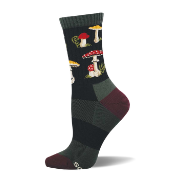 Single dark crew sock with a repeating pattern of red and white spotted mushrooms, yellow-capped mushrooms, and green foliage. Dark green cuff, burgundy heel and toe.