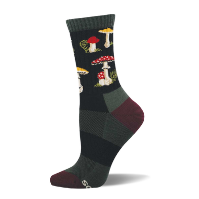 Single dark crew sock with a repeating pattern of red and white spotted mushrooms, yellow-capped mushrooms, and green foliage. Dark green cuff, burgundy heel and toe.