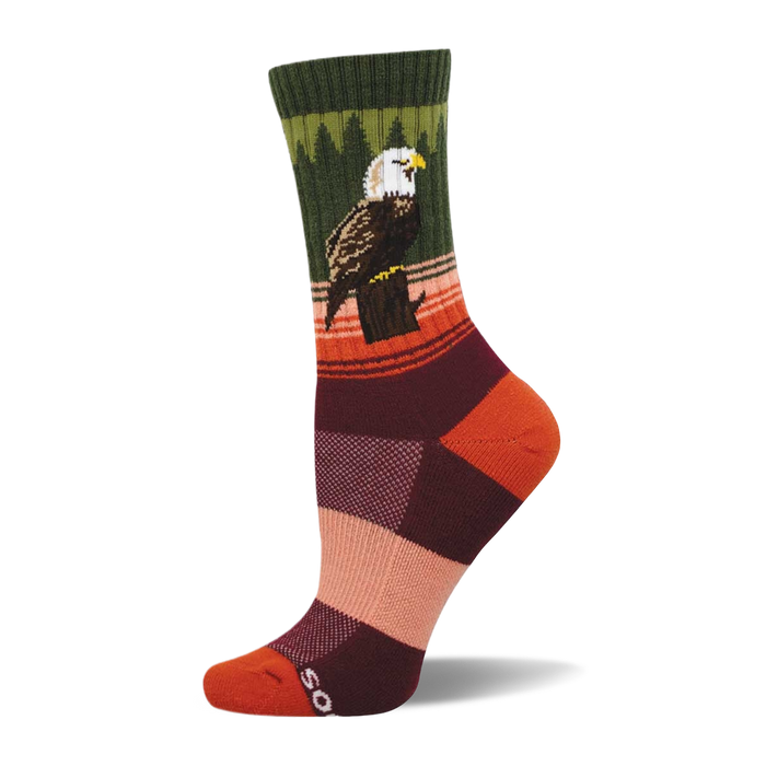 Crew sock with a bald eagle perched on a stump. Dark green cuff, green tree pattern, orange and brown stripes, color block foot. }}