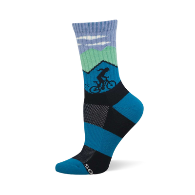 Blue and green crew sock with mountain scene, white clouds, and a dark silhouette of a cyclist. Blue and black checkerboard foot design.