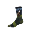 Crew sock with a bald eagle perched on a stump, dark pine trees, and blue sky. Green and dark green stripes on foot.