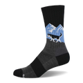 A single black crew sock featuring a black and white husky running over a grey hill with blue sky and white mountains.