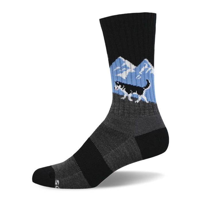 A single black crew sock featuring a black and white husky running over a grey hill with blue sky and white mountains. }}