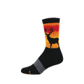 A black crew sock featuring a black stag silhouette against a striped red, orange, and yellow sunset design on the calf.