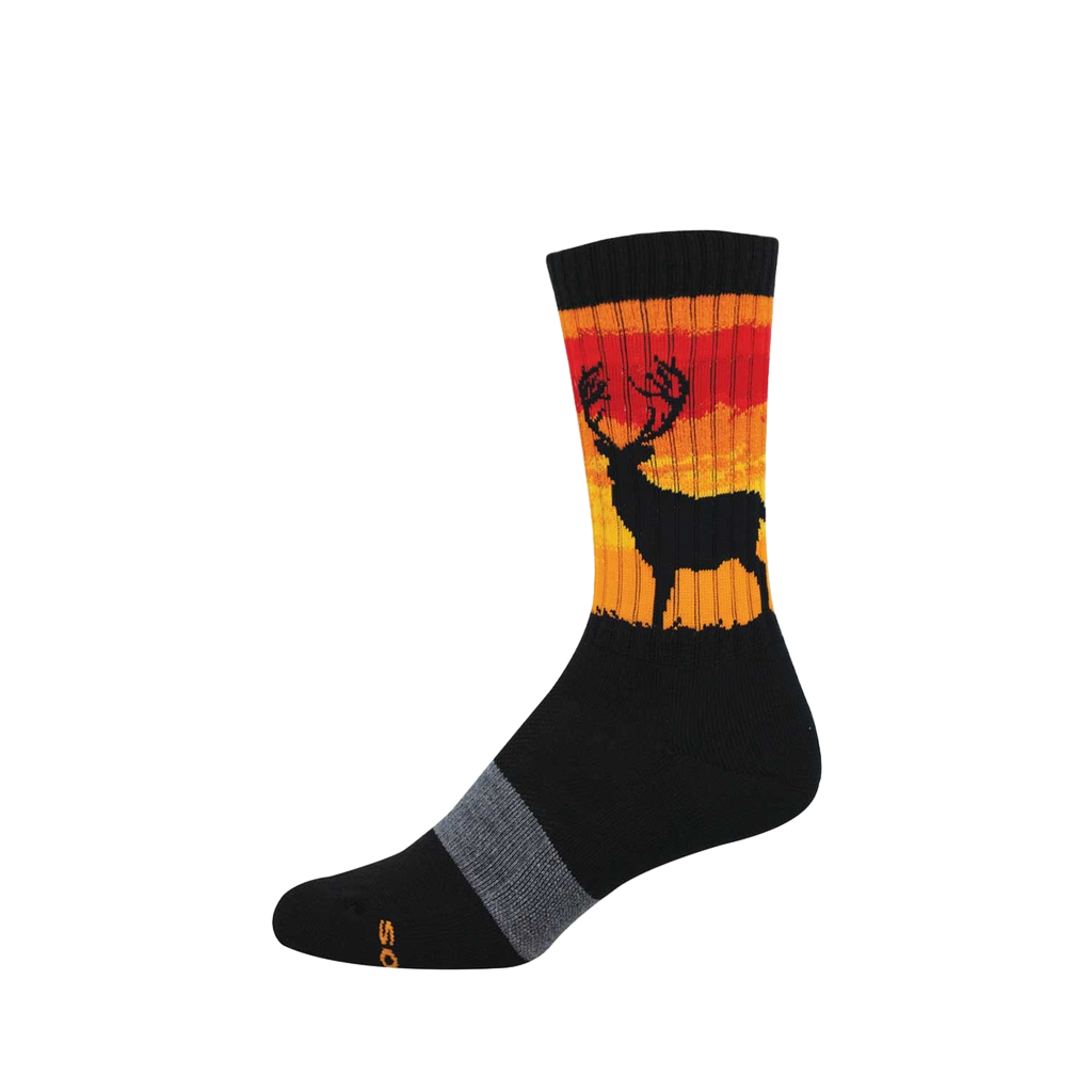 A black crew sock featuring a black stag silhouette against a striped red, orange, and yellow sunset design on the calf.