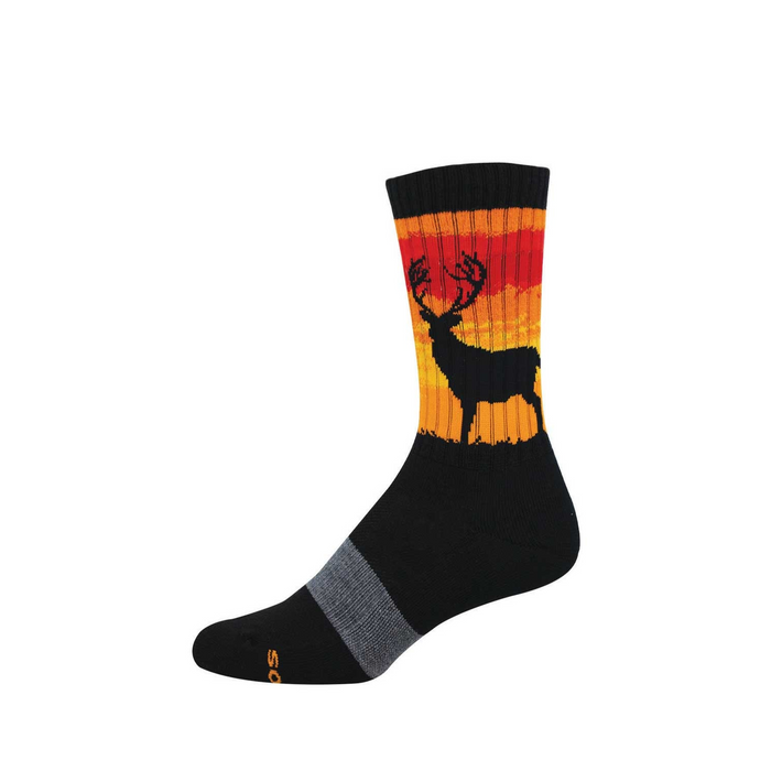 A black crew sock featuring a black stag silhouette against a striped red, orange, and yellow sunset design on the calf. }}