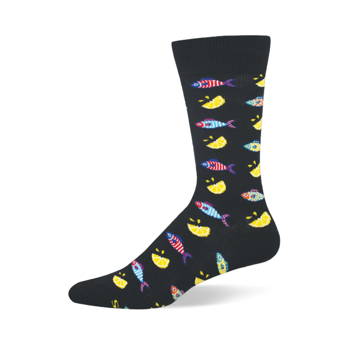 Black crew sock patterned with small colorful striped fishes and bright yellow lemon wedges, featuring a solid black toe. }}
