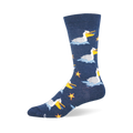 Navy blue crew sock showing a pattern of white pelicans floating on blue waves, holding fish near orange starfish.