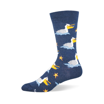 Navy blue crew sock showing a pattern of white pelicans floating on blue waves, holding fish near orange starfish.
