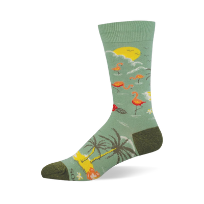 Light green crew sock showing a tropical scene with pink flamingos, a yellow sun, palm trees, and dark olive heel and toe.