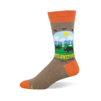 Heather brown crew sock with orange accents featuring a Yellowstone scene with bison, geysers, mountains, and trees.