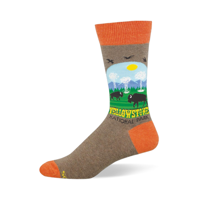 Heather brown crew sock with orange accents featuring a Yellowstone scene with bison, geysers, mountains, and trees.