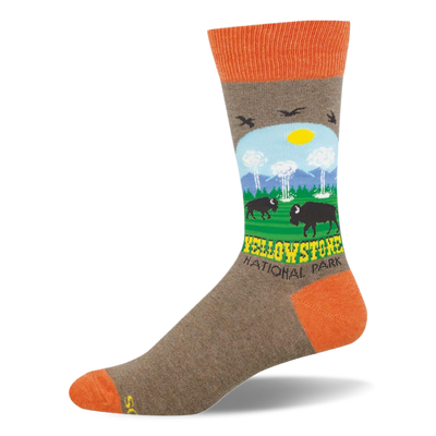 Heather brown crew sock with orange accents featuring a Yellowstone scene with bison, geysers, mountains, and trees.
