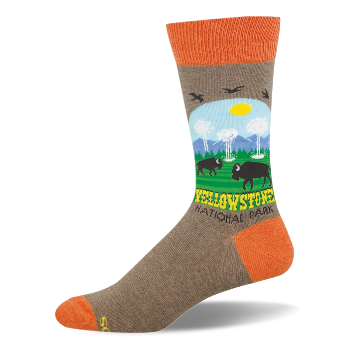 Heather brown crew sock with orange accents featuring a Yellowstone scene with bison, geysers, mountains, and trees. }}