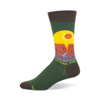 Green crew sock with brown accents featuring a retro Grand Canyon National Park graphic, yellow sun, and red cliffs.