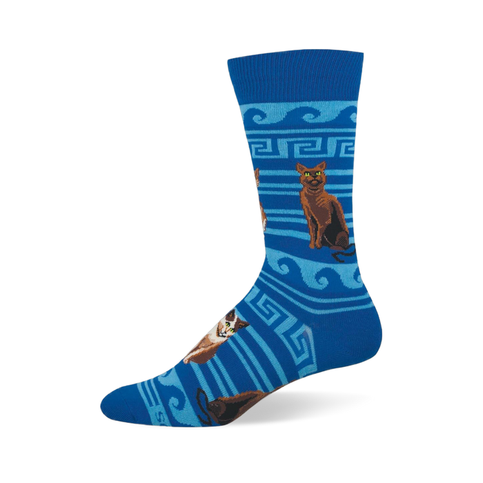 Blue crew sock with brown and calico cats sitting among light blue Greek key patterns, waves, and stripes. }}