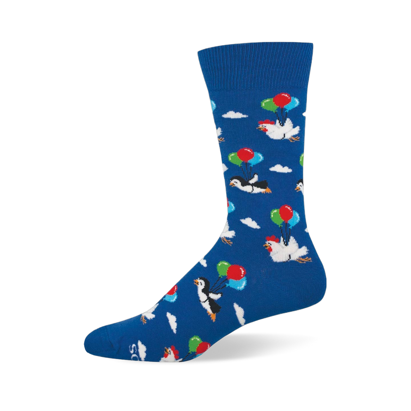 Blue crew sock showing a pattern of penguins and chickens floating among white clouds using bunches of colorful balloons.