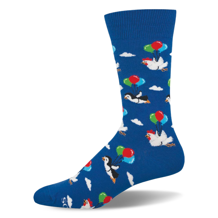Blue crew sock showing a pattern of penguins and chickens floating among white clouds using bunches of colorful balloons. }}