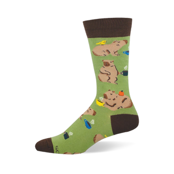 Light green crew sock featuring lounging capybaras, steaming coffee mugs, and a small yellow bird.