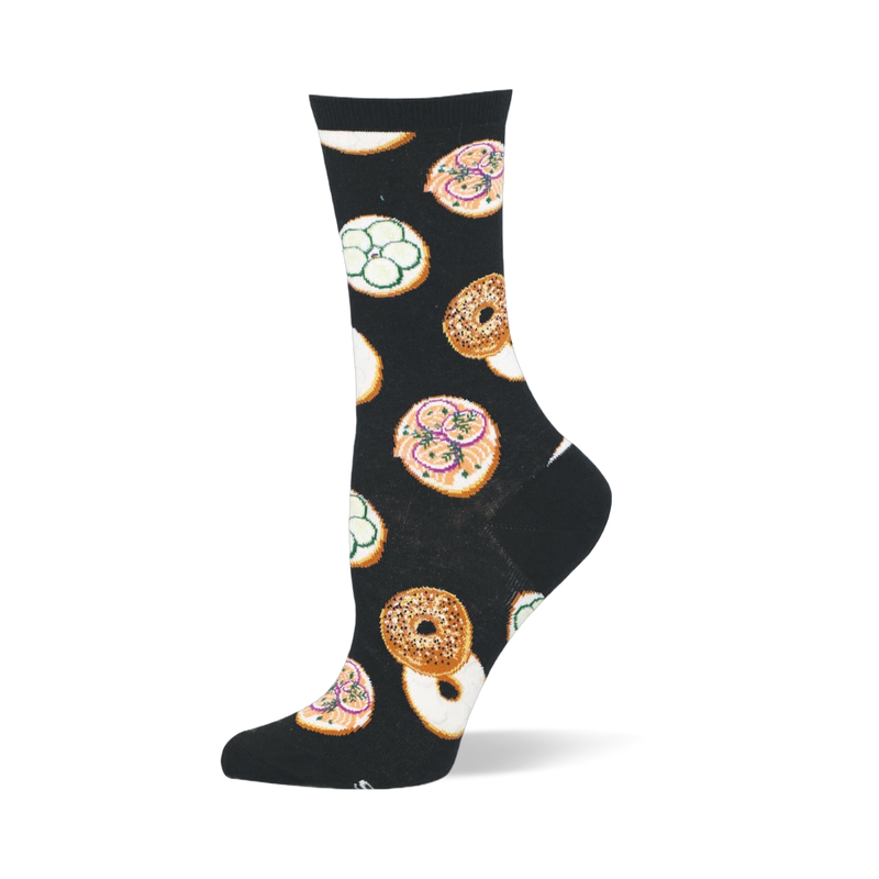 Black crew sock featuring a pattern of whole seeded bagels and open-faced bagel halves with pink lox and green cucumbers.