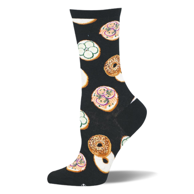Black crew sock featuring a pattern of whole seeded bagels and open-faced bagel halves with pink lox and green cucumbers.