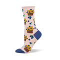 Light pink crew socks patterned with yellow blueberry muffins in brown wrappers and scattered blueberries with green leaves.