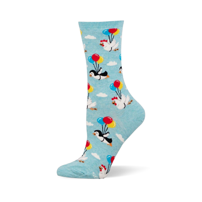 Light blue socks showing flightless penguins and chickens floating among white clouds while holding colorful party balloons.