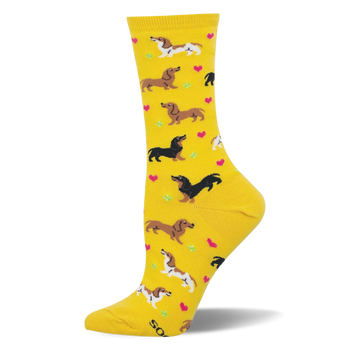 Yellow crew socks featuring brown dachshunds, spotted dachshunds, pink hearts, and green tennis balls.